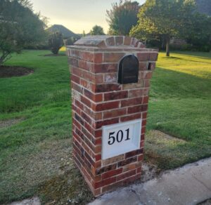 Finished brick mailbox rebuild with new black mailbox and white address panel